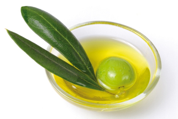 Image Small bowl with olive oil and olive in it.